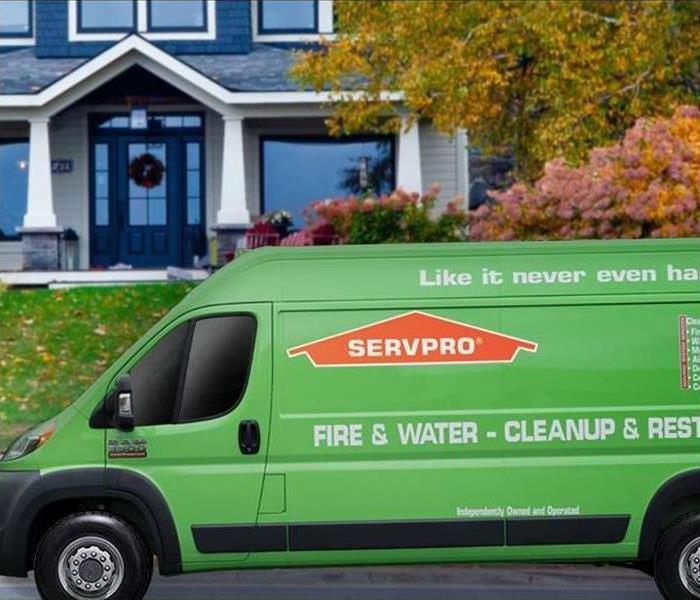 SERVPRO® vehicle parked in front of a building