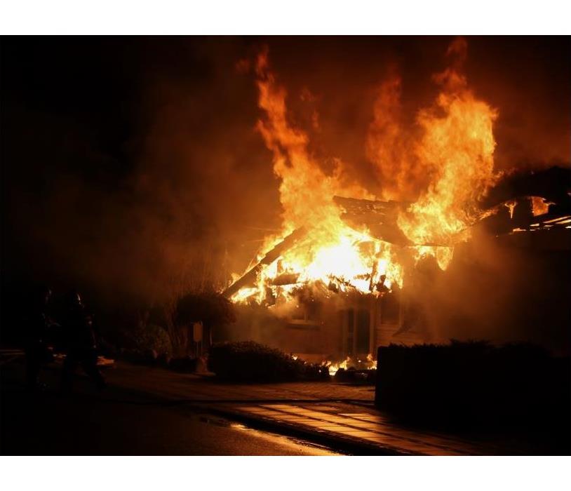 < img src =” fire.jpg” alt = " a large house fire completely engulfing a small house “>